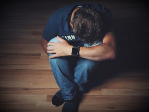 man sitting trying to overcome discouragement