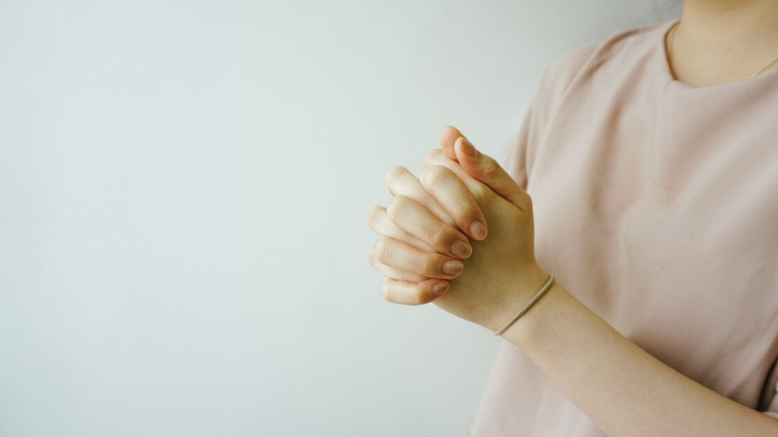 a lady praying because she know the privilege of prayer